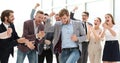 Happy young businessman standing in front of his business team. Royalty Free Stock Photo