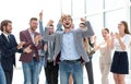 Happy young businessman standing in front of his business team. Royalty Free Stock Photo