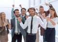 Happy young businessman standing in front of his business team Royalty Free Stock Photo