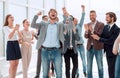 Happy young businessman standing in front of his business team. Royalty Free Stock Photo