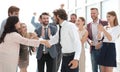 Happy young businessman standing in front of his business team Royalty Free Stock Photo