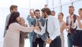 Happy young businessman standing in front of his business team Royalty Free Stock Photo