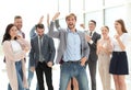 happy young businessman standing in front of his business team. Royalty Free Stock Photo