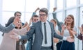 Happy young businessman standing in front of his business team. Royalty Free Stock Photo