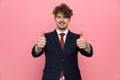 Happy young businessman in suit making thumbs up gesture Royalty Free Stock Photo