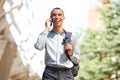 Happy young businessman talking on mobile phone in the city Royalty Free Stock Photo