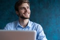 Happy young businessman using laptop at his office desk. Royalty Free Stock Photo