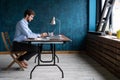 Happy young businessman using laptop at his office desk. Royalty Free Stock Photo