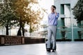 Happy Young Businessman Using Mobile Phone while Walking with Suitcase in the City. Lifestyle of Modern People. High Angle View. Royalty Free Stock Photo