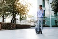 Happy Young Businessman Using Mobile Phone while Walking with Suitcase in the City. Lifestyle of Modern People Royalty Free Stock Photo