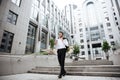 Happy young businessman walking and drinking coffee Royalty Free Stock Photo