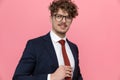 Happy young businessman wearing glasses and arranging tie Royalty Free Stock Photo