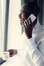 happy young businessman in white shirt talking by phone during coffee break and looking