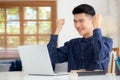 Happy young businessman work on laptop computer finish with excited and success on desk at home. Royalty Free Stock Photo