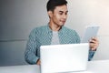 Happy Young Businessman Working on Computer Laptop and Digital Tablet Royalty Free Stock Photo