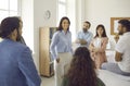 Happy young businesswoman or business coach having a meeting with a group of people Royalty Free Stock Photo