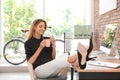 Happy young businesswoman with cup of coffee Royalty Free Stock Photo