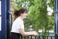 Happy young businesswoman leaning on railing while looking away Royalty Free Stock Photo