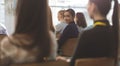 Happy young businesswoman looking at camera during seminar Royalty Free Stock Photo