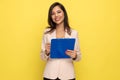 Happy young businesswoman in pink suit taking notes on clipboard Royalty Free Stock Photo