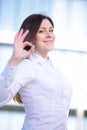 Happy young businesswoman showing ok sign isolated on a white background Royalty Free Stock Photo