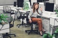 Happy young businesswoman showing ok sign and smiling at camera