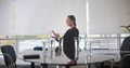 Happy young businesswoman sitting on chair in boardroom Royalty Free Stock Photo