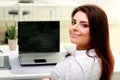 Happy young businesswoman sitting at the table on her workplace Royalty Free Stock Photo