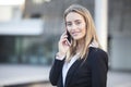 Happy young businesswoman talking on mobile phone outdoors Royalty Free Stock Photo