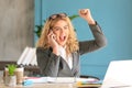 Happy young businesswoman talking on phone in office Royalty Free Stock Photo