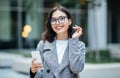 Happy Young Businesswoman Using Mobile Phone Standing In Urban Area Royalty Free Stock Photo