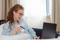 Happy young businesswoman using tablet pc in hotel room. Online shopping with credit card. Royalty Free Stock Photo