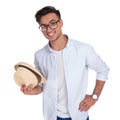 Happy young casual man holds hat and smiles Royalty Free Stock Photo