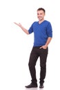 Happy young casual man presenting something Royalty Free Stock Photo