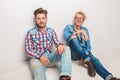 Happy young casual men sitting on the floor Royalty Free Stock Photo