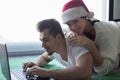 Happy young couple online shopping on carpet for Christmas Royalty Free Stock Photo