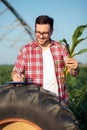 Young agronomist or farmer filling questionnaire in corn field Royalty Free Stock Photo