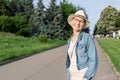 Happy young caucasian bald woman in hat and casual clothes enjoying life after surviving breast cancer. Portrait of