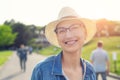 Happy young caucasian bald woman in hat and casual clothes enjoying life after surviving breast cancer. Portrait of beautiful