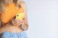 Happy young caucasian blonde woman blogger sharing good news at social media via mobile phone on white background with Royalty Free Stock Photo