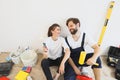 Happy young caucasian couple holding paint rollers during renovation Royalty Free Stock Photo