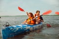 Happy couple kayaking on river with sunset on the background Royalty Free Stock Photo