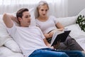 Happy young caucasian couple or lover on bed together. Man read book for woman in dreamy romantic moment in bedroom. Photo of marr Royalty Free Stock Photo