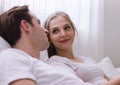 Happy young caucasian couple or lover on bed together. Man read book for woman in dreamy romantic moment in bedroom. Photo of marr Royalty Free Stock Photo