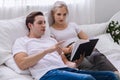 Happy young caucasian couple or lover on bed together. Man read book for woman in dreamy romantic moment in bedroom. Photo of marr Royalty Free Stock Photo