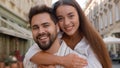 Happy young Caucasian couple man woman cuddling hugging hug embrace together love enjoy smile family honeymoon outside Royalty Free Stock Photo