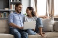 Happy couple relax on sofa using laptop together Royalty Free Stock Photo