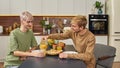 Happy young caucasian homosexual pair sitting at table Royalty Free Stock Photo