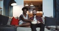 Happy young Caucasian man and African woman sit at home watching dramatic movie together, eating popcorn slow motion. Royalty Free Stock Photo