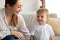 Happy young caucasian mother enjoying time with her child boy, looking at son and smiling, playing together at home Royalty Free Stock Photo